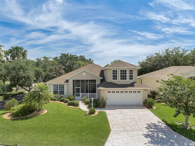 view of front of property with a front yard, decorative driveway, and an attached garage