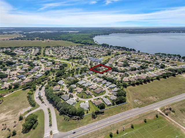 drone / aerial view with a water view and a residential view