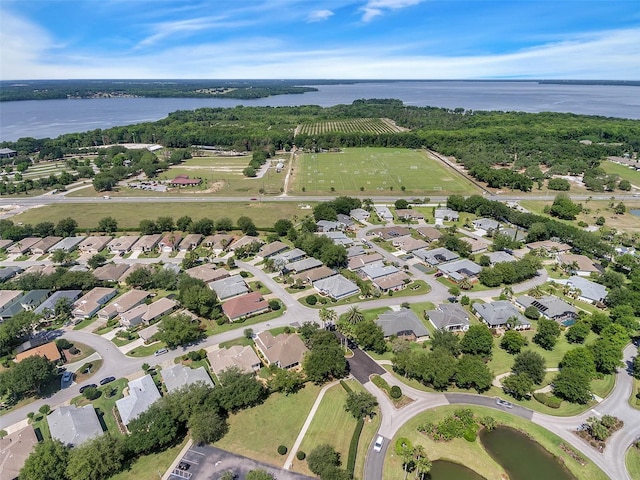 drone / aerial view with a water view and a residential view