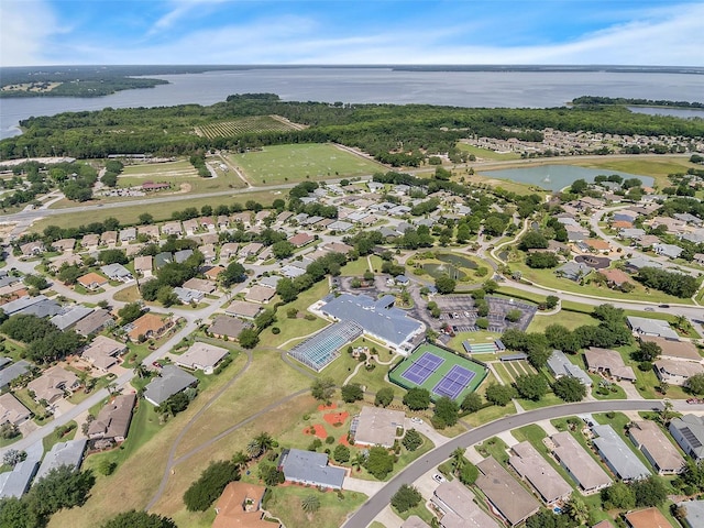 drone / aerial view featuring a residential view and a water view