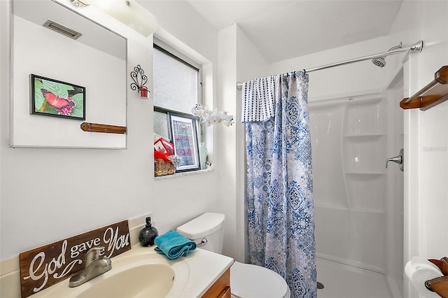 full bathroom with visible vents, a stall shower, toilet, and vanity