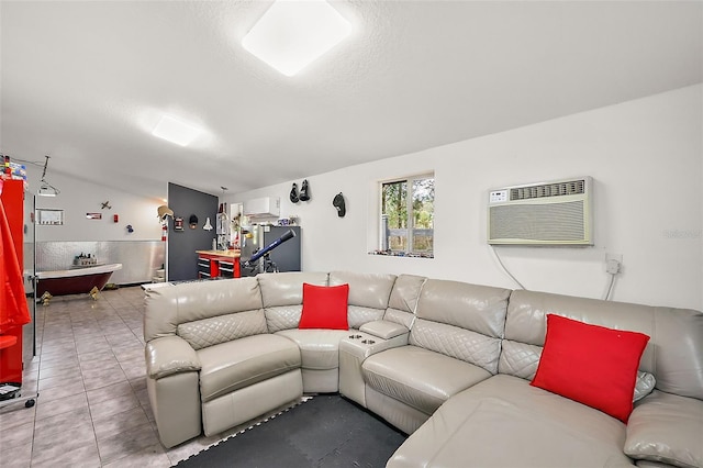 living area with tile patterned flooring, a textured ceiling, and an AC wall unit