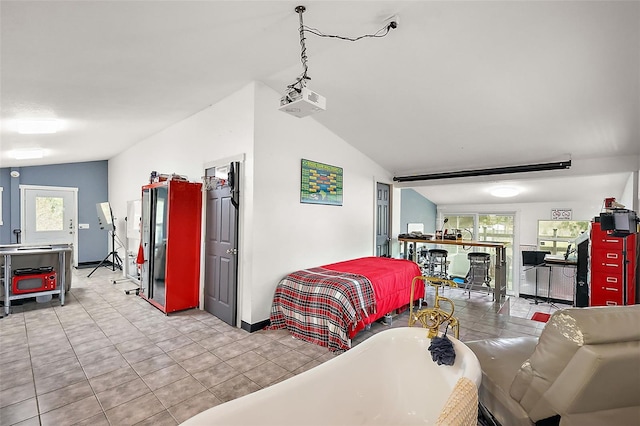 tiled bedroom featuring vaulted ceiling