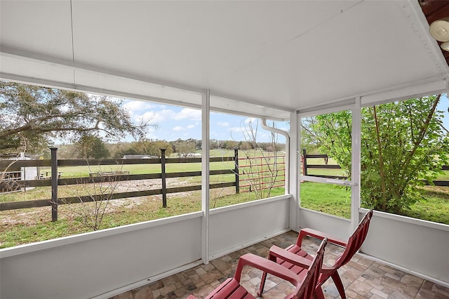 sunroom featuring a rural view