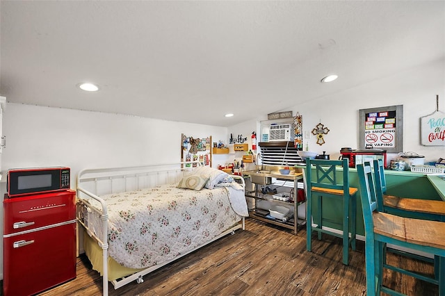 bedroom featuring vaulted ceiling, recessed lighting, and wood finished floors