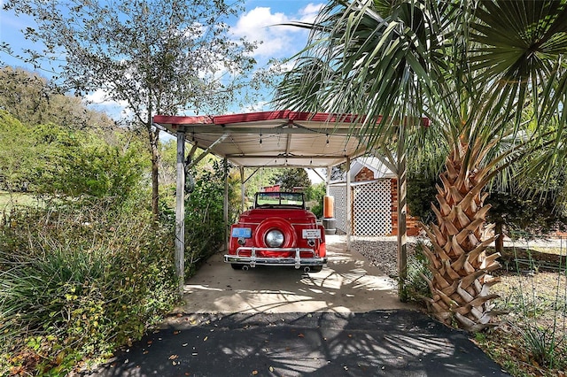 view of car parking with aphalt driveway and a carport