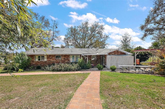 ranch-style home with brick siding, a garage, and a front yard