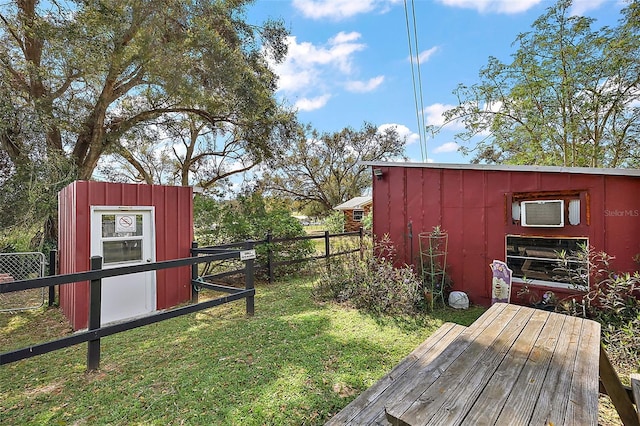 view of yard featuring an outdoor structure, a shed, and fence