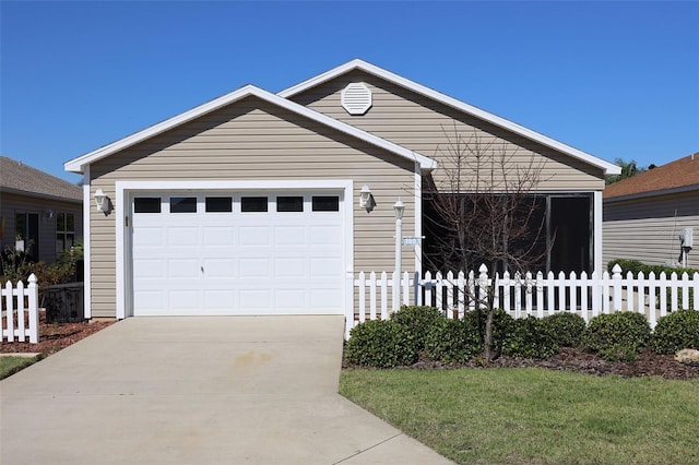 view of front of home with fence and concrete driveway