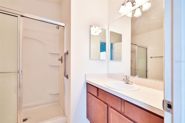 bathroom featuring a shower stall and vanity