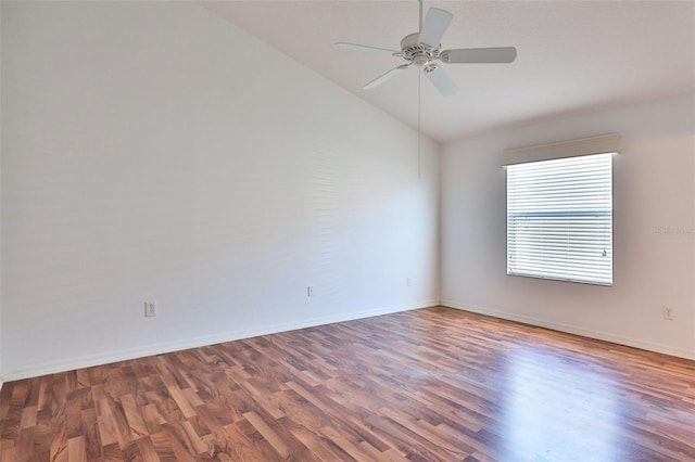 empty room featuring a ceiling fan, vaulted ceiling, baseboards, and wood finished floors