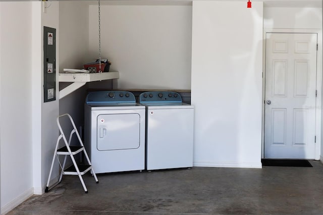 laundry area featuring laundry area, washing machine and dryer, and baseboards