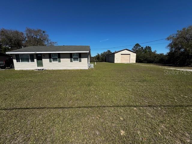 view of front of house with an outbuilding and a front yard