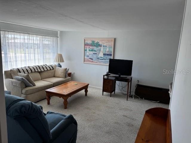 living room with baseboards and carpet