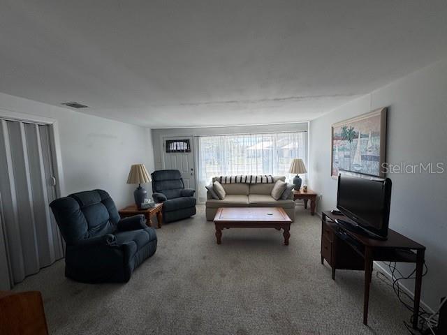 carpeted living area featuring visible vents