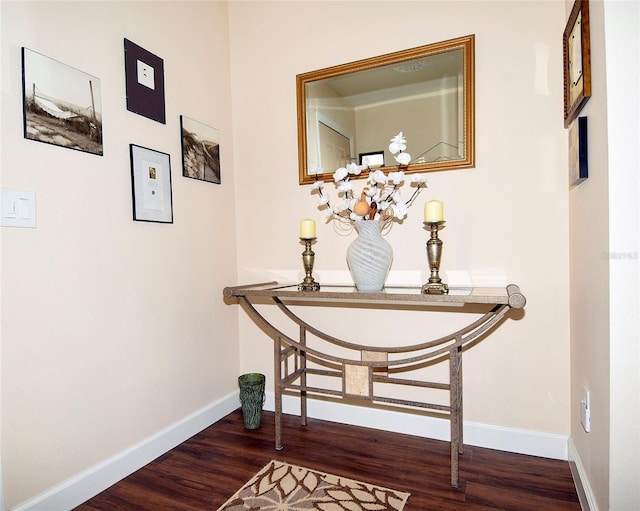 interior space featuring baseboards and dark wood-style flooring