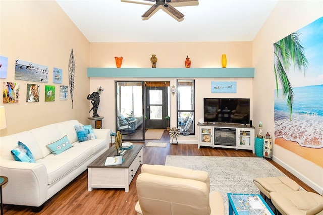 living room with a ceiling fan, wood finished floors, and baseboards