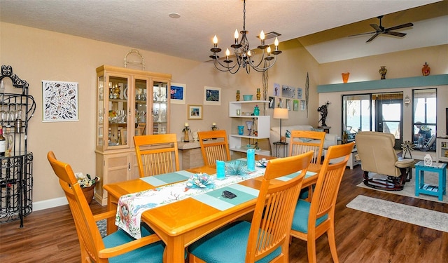 dining room featuring baseboards, lofted ceiling, wood finished floors, a textured ceiling, and a ceiling fan