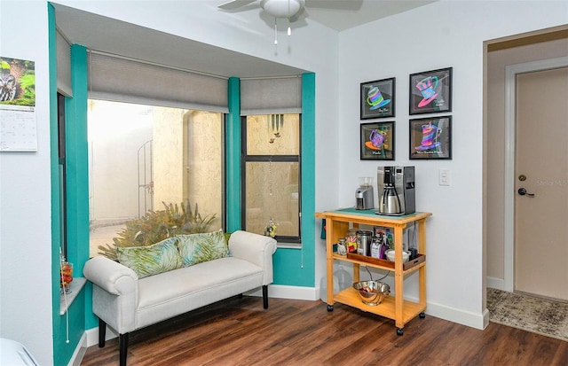 sitting room featuring wood finished floors, baseboards, and ceiling fan