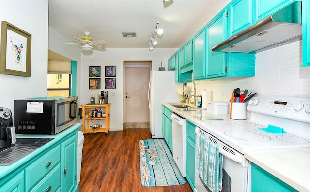 kitchen with white appliances, visible vents, dark wood-style flooring, a sink, and under cabinet range hood