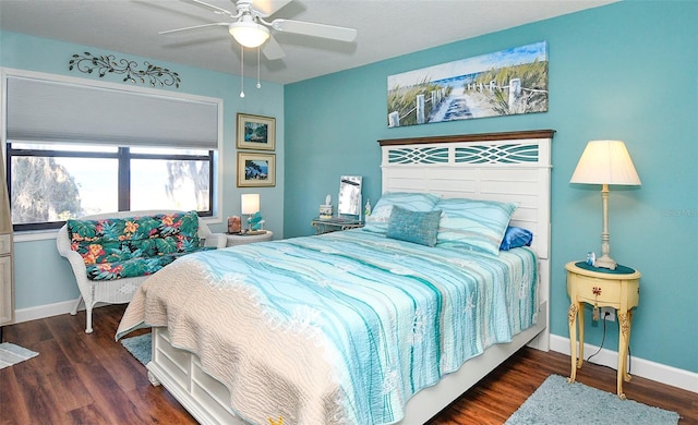 bedroom with ceiling fan, baseboards, and wood finished floors