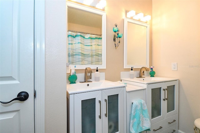 bathroom featuring two vanities and a sink