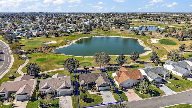 drone / aerial view featuring a residential view, a water view, and golf course view