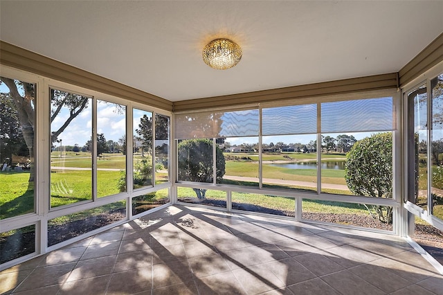 unfurnished sunroom featuring a water view