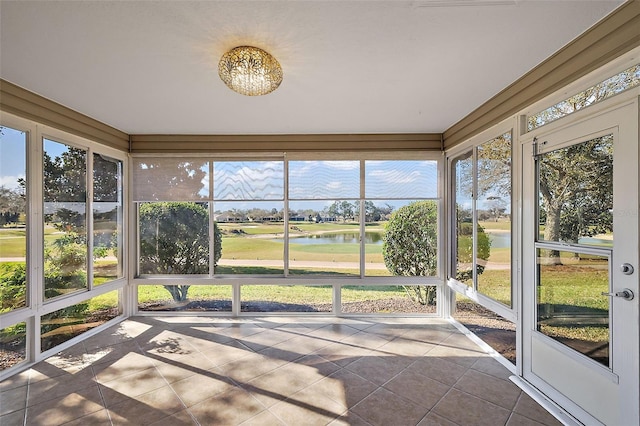 unfurnished sunroom featuring a water view