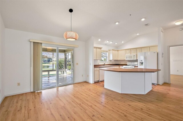 776 Alcott Ave, The Villages, FL 32162 - kitchen featuring visible vents, lofted ceiling, light wood-style flooring, hanging light fixtures, and white appliances