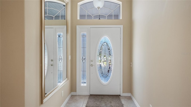 foyer entrance with baseboards and light tile patterned floors