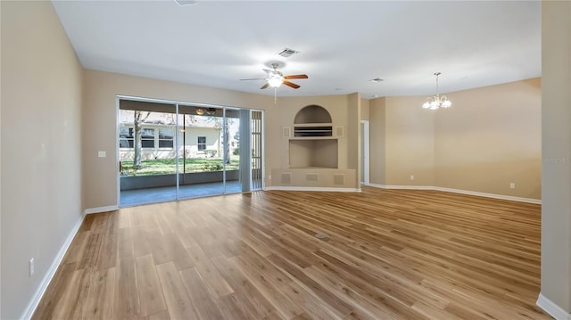 unfurnished living room featuring light wood-style flooring, visible vents, baseboards, and ceiling fan with notable chandelier