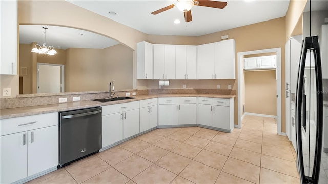 kitchen featuring light countertops, dishwasher, refrigerator with ice dispenser, and a sink