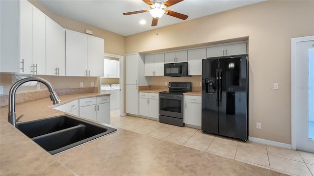 kitchen featuring washer and dryer, light countertops, a sink, and black appliances