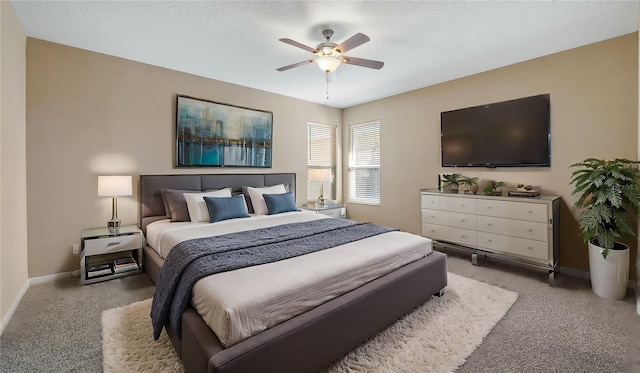 bedroom with light carpet, baseboards, and a ceiling fan