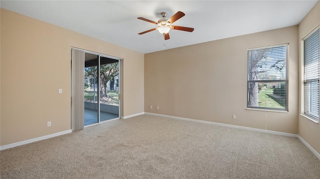 spare room featuring carpet, baseboards, and ceiling fan