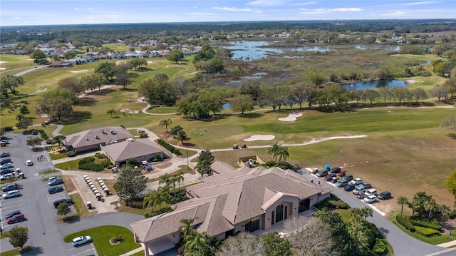 drone / aerial view featuring view of golf course and a water view