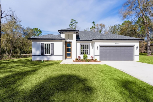 view of front of home featuring a garage, driveway, roof with shingles, stucco siding, and a front yard