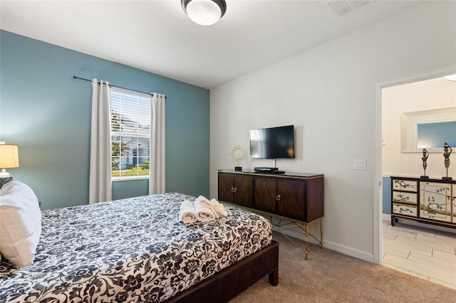 carpeted bedroom with baseboards and visible vents