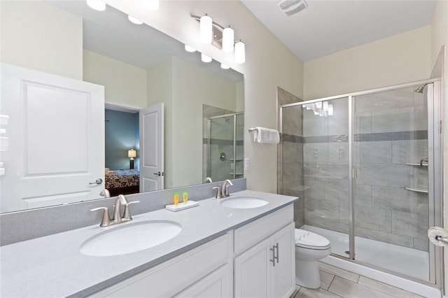 bathroom with a stall shower, visible vents, a sink, and ensuite bathroom