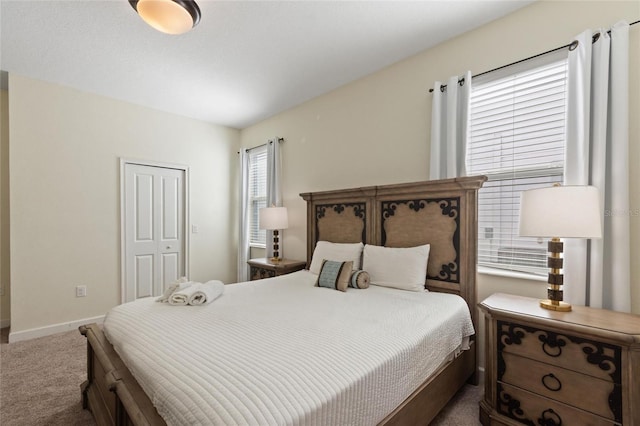 carpeted bedroom with baseboards