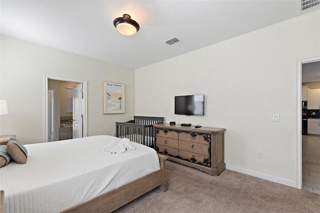 carpeted bedroom featuring connected bathroom, visible vents, and baseboards