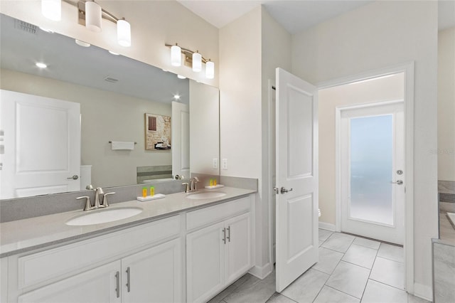 full bathroom featuring tile patterned flooring, visible vents, a sink, and double vanity