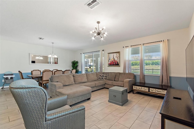 living room with visible vents and a notable chandelier