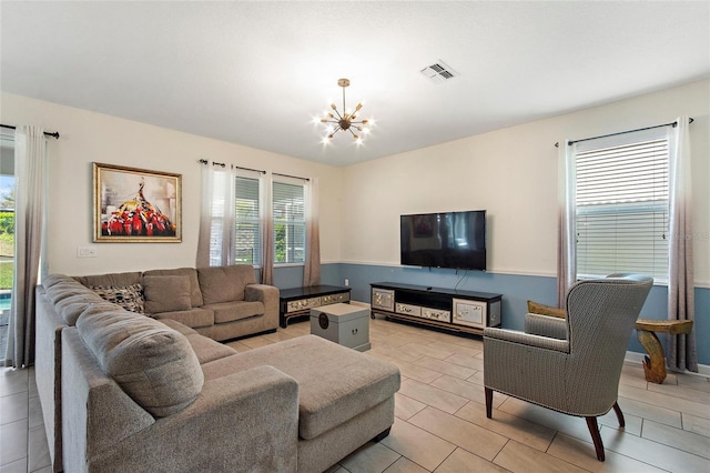 living area with an inviting chandelier and visible vents