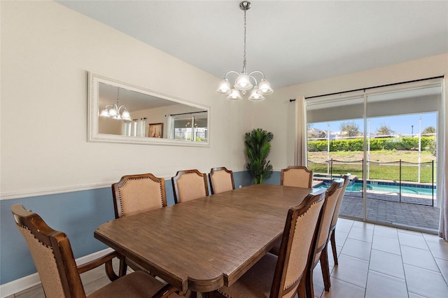 dining area with a chandelier, baseboards, and light tile patterned floors