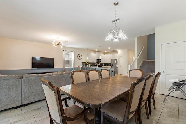 dining space with a chandelier, light tile patterned floors, visible vents, and stairs