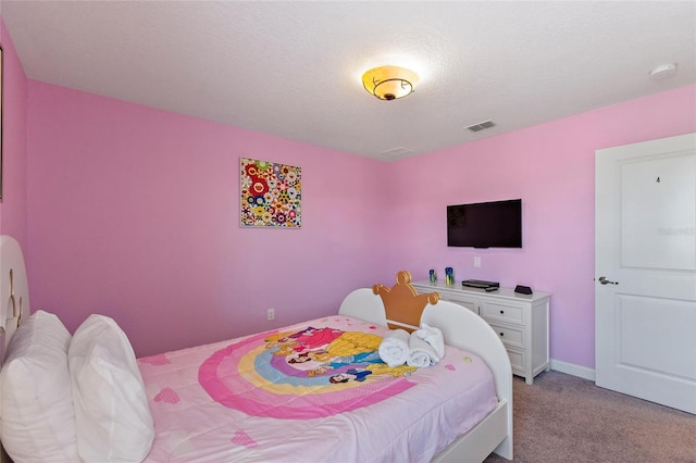 bedroom featuring baseboards, visible vents, light carpet, and a textured ceiling