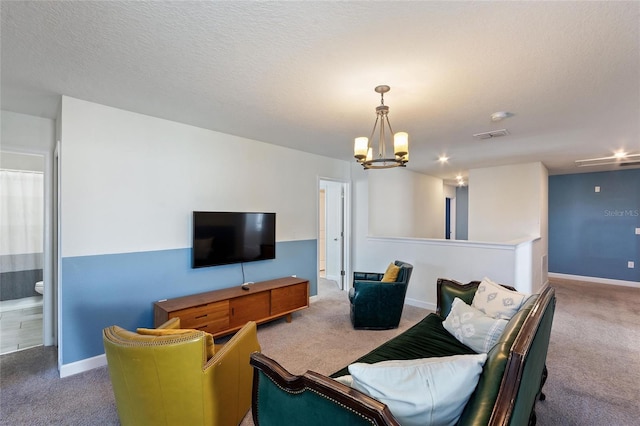 living area with a textured ceiling, baseboards, and carpet flooring