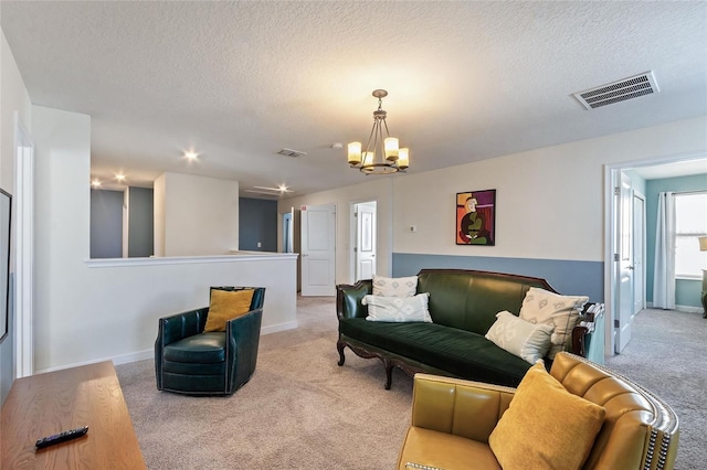 living room with visible vents, a textured ceiling, and light colored carpet